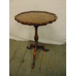 A mahogany wine table pie crust border on three outswept legs