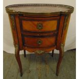 An early 20th century French two drawer cabinet of oval form with applied brass mounts and galleried