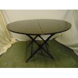 Thornton & Herne mahogany circular folding table with brass hinges on scissor base