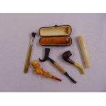 Three tobacco pipes, a cigarette holder and two cheroot holders, one in original case (6)