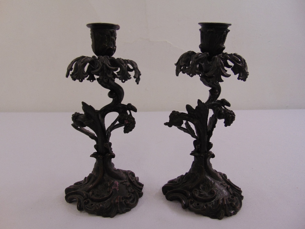 A pair of 19th century bronze candlesticks of naturalistic form in the rococo style