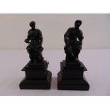 A pair of 19th century cast bronze figurines of Romans in military attire on rectangular stepped