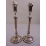 A pair of Israeli white metal table candlesticks, tapering cylindrical on raised circular bases