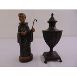 An Atelier figurine of a monk and a bronze classical urn with pull off cover