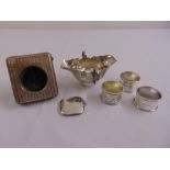 A twin handled silver hallmarked sauce boat London 1902, three silver napkin rings, a silver vesta