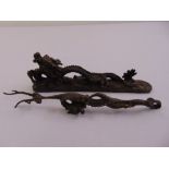Two Chinese bronze figurines to include a dragon paperweight and a fork