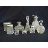 A quantity of cut glass perfume and dressing table bottles with silver covers and collars (9)