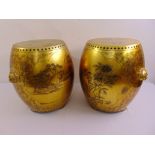 A pair of oriental gold lacquered barrel shaped garden seats decorated with floral and leaf
