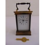 A brass carriage clock by L. Epee of France of customary form, to include key