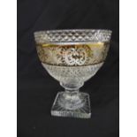 A cut glass circular bowl on raised square base with gilded decorations