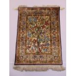 A Persian silk rectangular wall hanging decorated with birds and flowers against a cream ground with