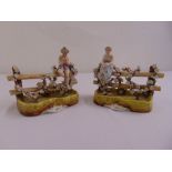 A pair of Sitzendorf figurines of a boy playing pipes and a girl sitting on a fence
