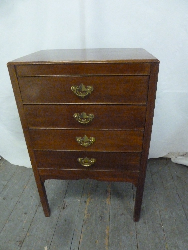 A mahogany rectangular sheet music cabinet with four drop-front drawers on four rectangular legs