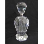 An Art Deco glass perfume bottle with screw off stopper on raised octagonal base