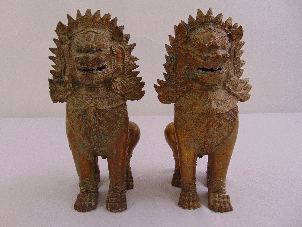 A pair of oriental gilded bronzed stylized dogs of foe