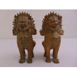 A pair of oriental gilded bronzed stylized dogs of foe