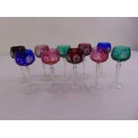 A set of ten coloured cut glass wine glasses