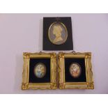 A pair of framed miniatures of ladies in classical dress and a framed wax profile a classical lady