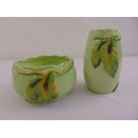 Clarice Cliff green ground bowl decorated with a stylised leaf and branch 833 and a matching vase