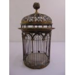 A Victorian cylindrical brass birdcage with scroll pierced arched top and bud finial