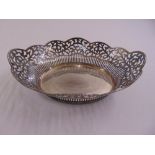 A shaped oval silver pierced roll basket with beaded border, import mark