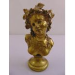 A cast brass figurine of a classical female, adorned with vines on raised circular plinth