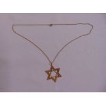 A yellow gold Star of David pendant on a yellow gold chain, gold tested 14ct, approx total weight