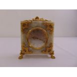 A Swiss gilt metal and marble square mantle clock with Roman numerals and four paw feet