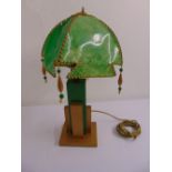 An Art Deco table lamp, green and gold painted geometric column with green shade on rectangular