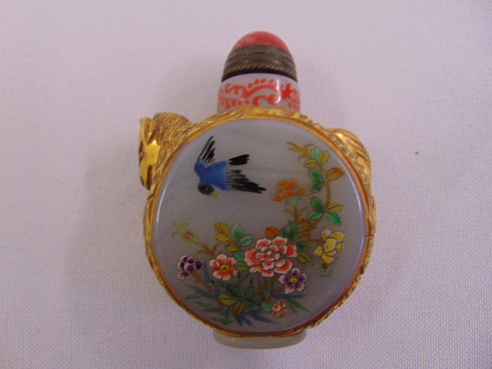 A Chinese Peking glass snuff bottle decorated with birds and flowers