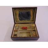 A Victorian rectangular travelling vanity case the hinged cover revealing scent bottles with drop