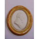 An oval Parianware framed wooden plaque of a classical bust, A/F