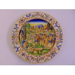 A 19th century Italian faience majolica tin glazed earthenware charger depicting an army at the