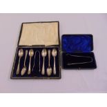 A cased set of six silver teaspoons with a pair of sugar tongs and a cased pair of silver sugar