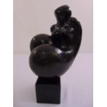 A bronzed abstract figurine in the style of Henry Moore on black square plinth