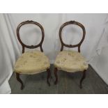 A pair of Victorian mahogany upholstered occasional chairs on four scroll legs