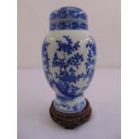 A Chinese blue and white vase and cover decorated with flowers and leaves, to include carved and