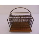 An Edwardian rectangular mahogany and brass magazine rack with central carrying handle