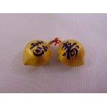 A pair of Korean gold dress buttons with enamel characters (tested 22ct gold) to include original