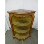 A Louis XVI style corner unit of triangular form with three shelves and applied gilded metal mounts