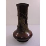A 19th century oriental bronze vase the sides chased with flowers and leaves