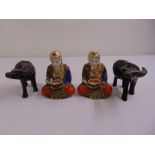 A pair of carved oriental oxen and a pair of Japanese Satsuma figurines