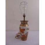 An oriental ceramic vase decorated with birds of paradise converted to a table lamp