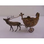 A late Victorian silver bonbon dish in the form of a stag pulling an open carriage on two wheels