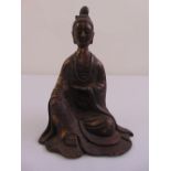 A Chinese cast metal figurine of a Buddha, character marks to verso