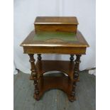 A rectangular mahogany desk with tooled leather hinged top, inlaid decoration on four turned knopped