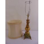 A gilded metal and onyx table lamp of vase form on raised square plinth to include silk shade