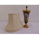 A porcelain tapering cylindrical table lamp with gilded metal mounts decorated with eighteenth