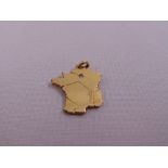A 14ct yellow gold pendant of a stylised map of France set with a diamond, approx total weight 3.5g