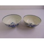 A pair of Worcester first period blue and white porcelain bowls decorated with flowers and
